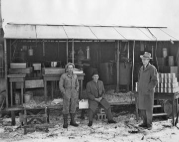 Bild Männer vor eine mobilen Konservenfabrik